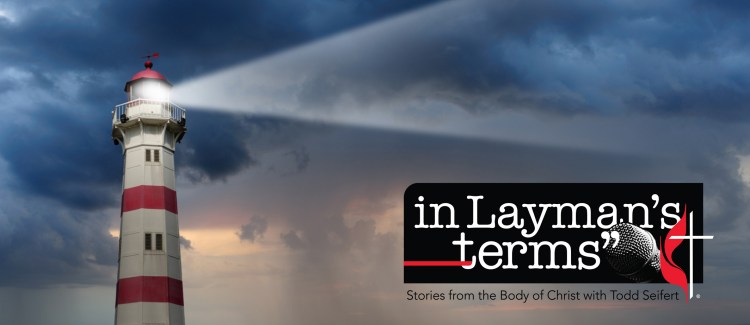 Partly sunlit lighthouse, bad weather in background